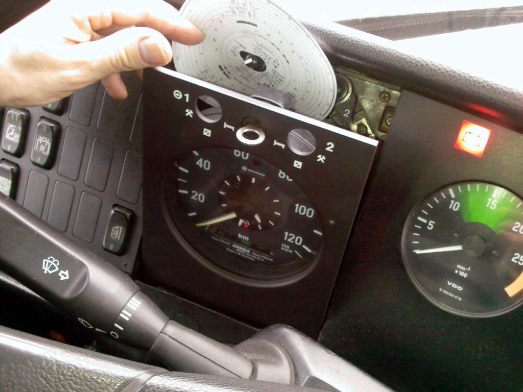 Broken speed dial with a circular piece of paper being removed from behind it