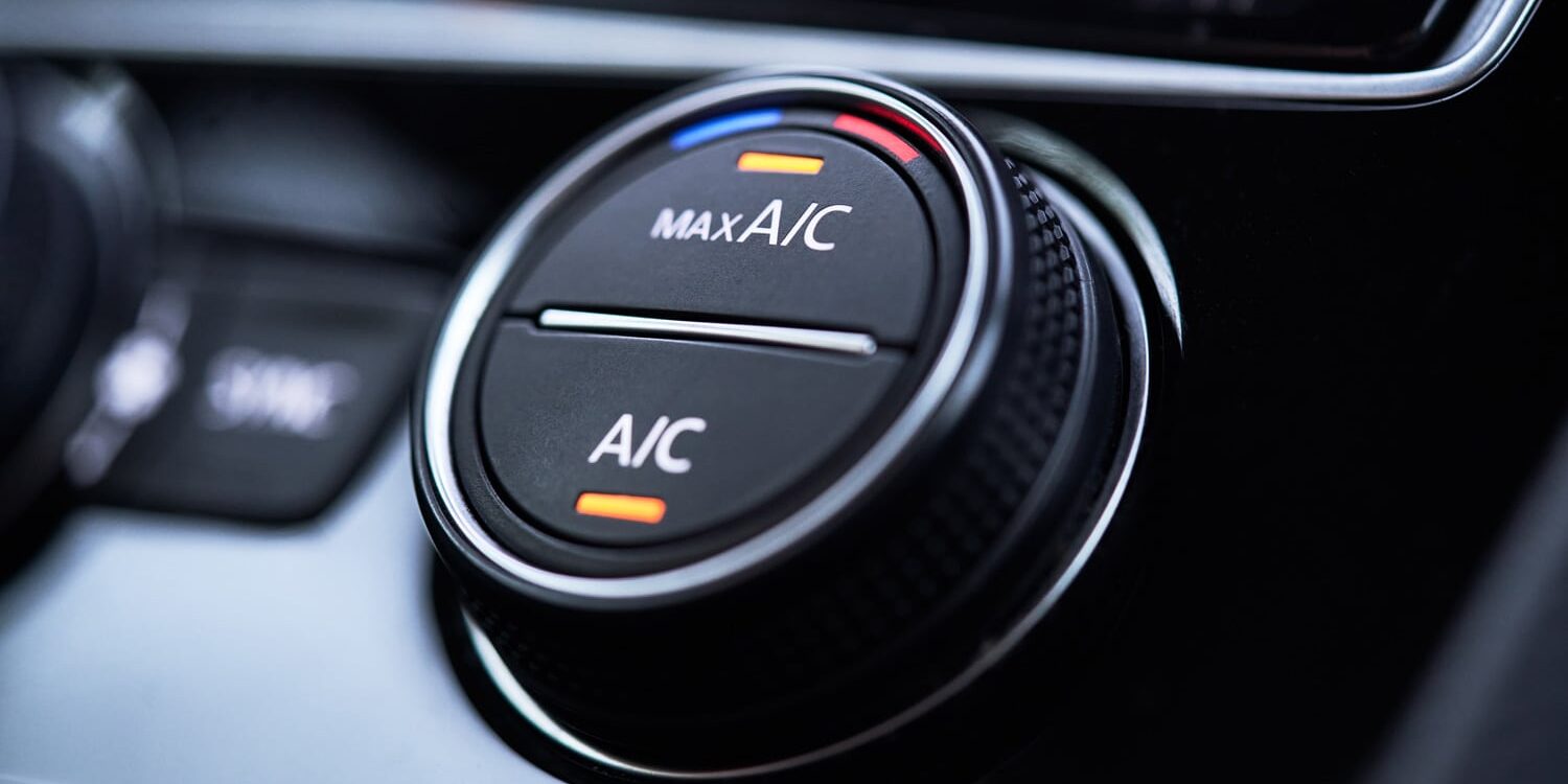 Close-up of a car air conditioning control dial with Max A/C and temperature settings.