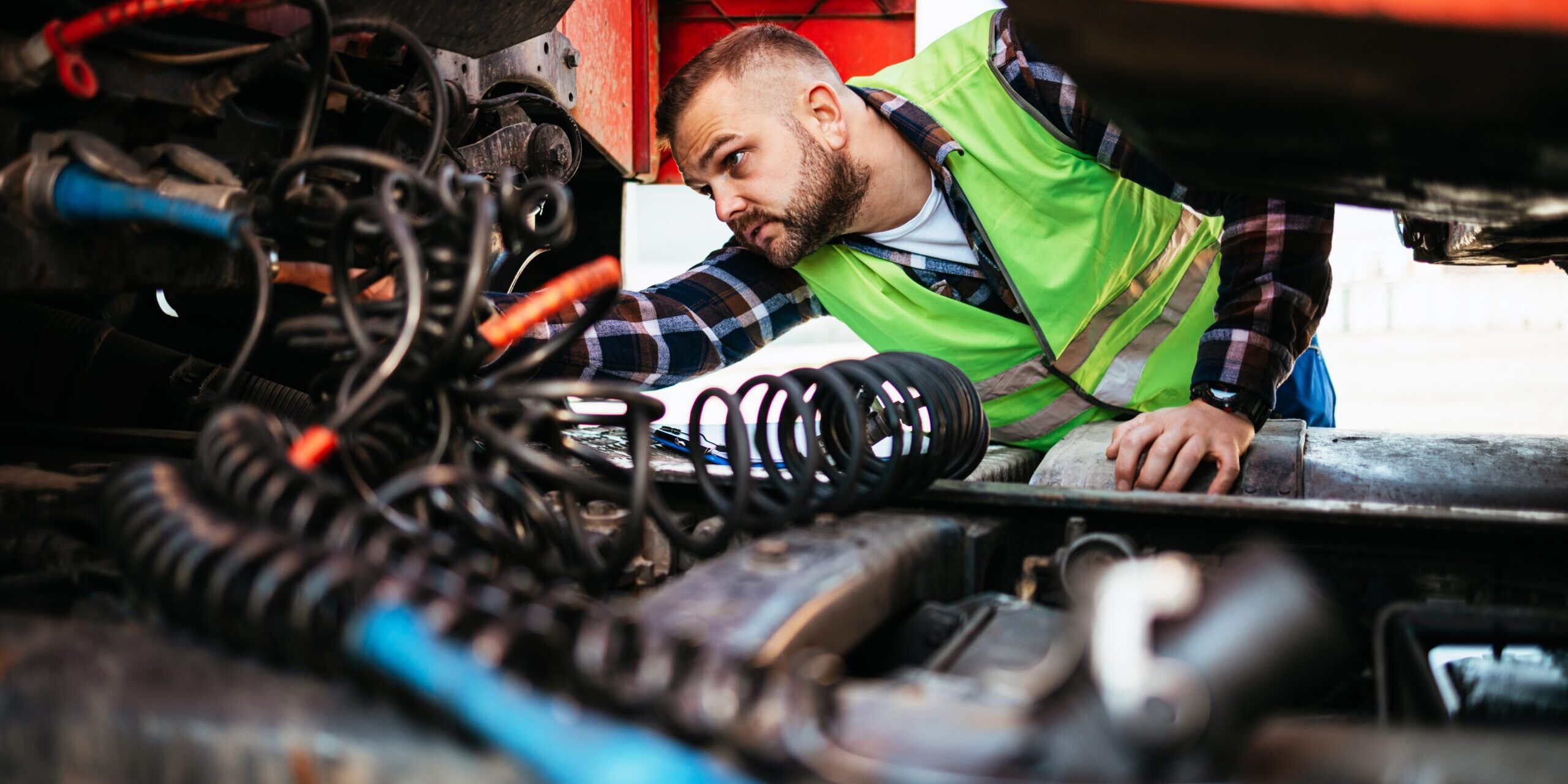 Man inspecting parts in a garage