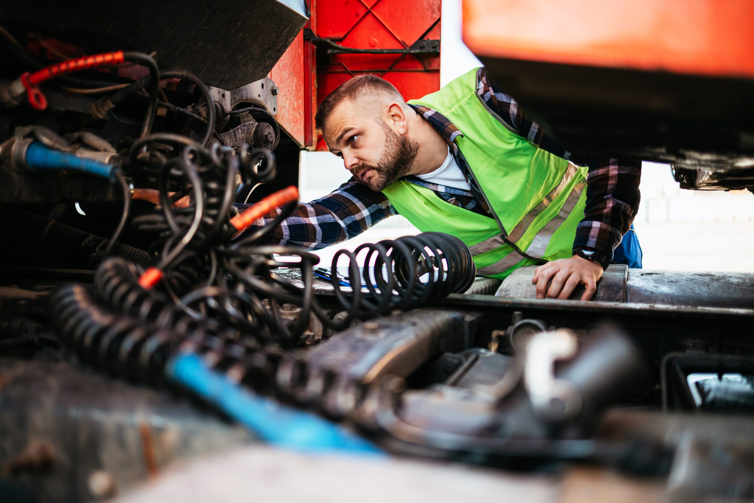 Man inspecting parts in a garage
