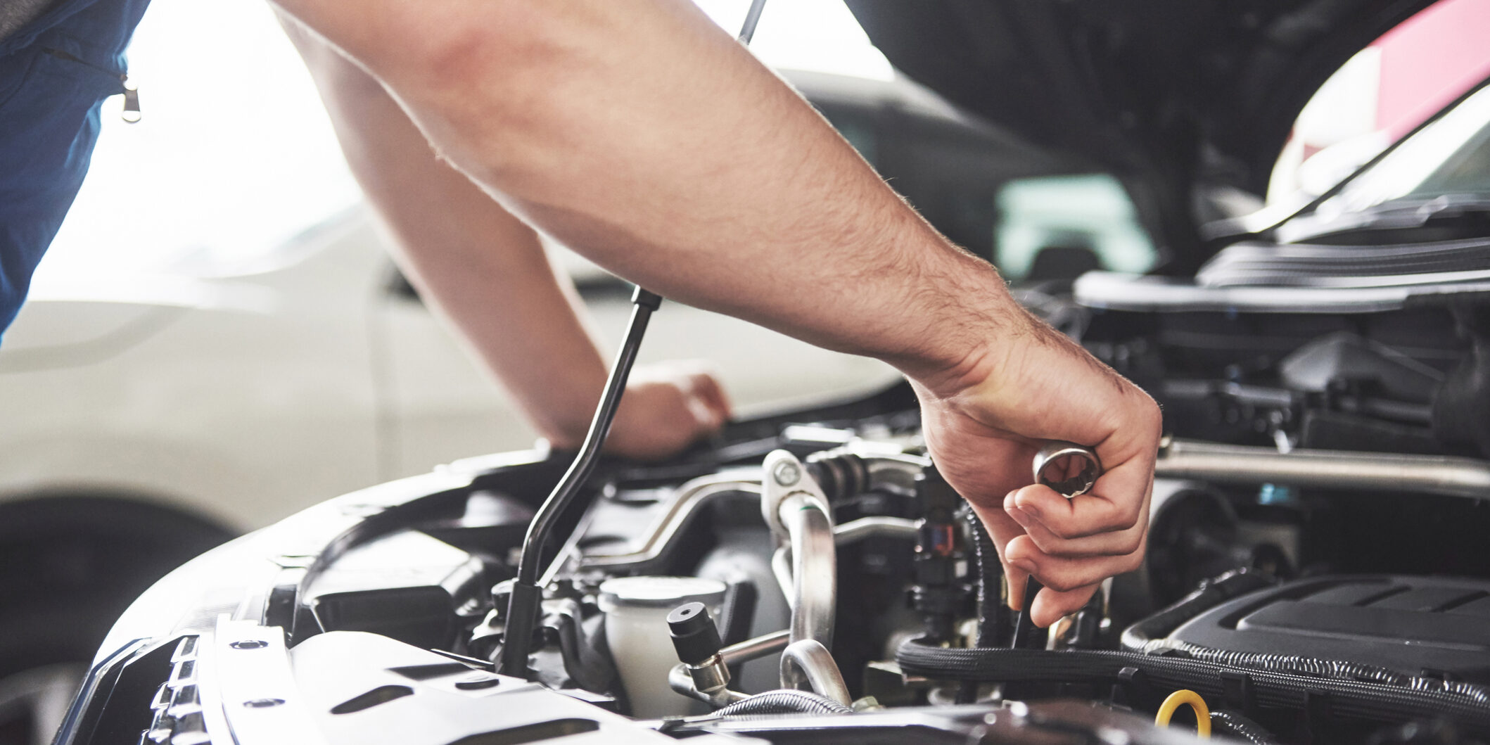 Man Working On Car Engine